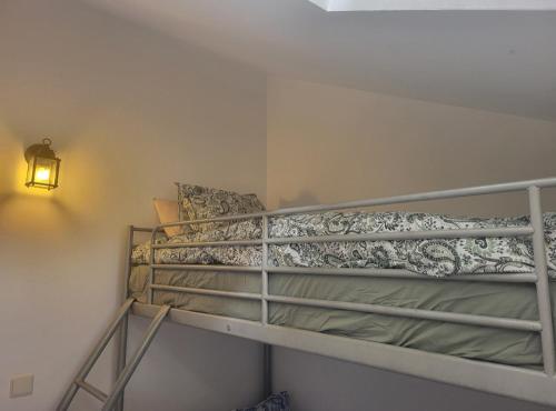 a bunk bed in a small room with a lamp at Ca Na Martina in Carreña de Cabrales 
