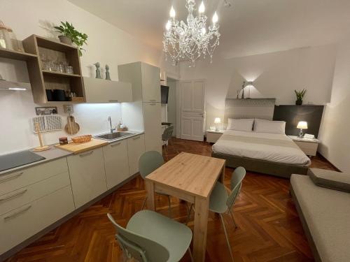 a kitchen and a bedroom with a bed and a table at La Suite dei Cristalli - Gorizia Central Apartment in Gorizia