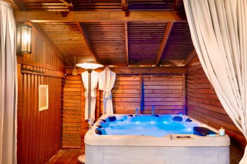 a bath tub in a room with a wooden ceiling at Mamilla View- Suites & Apt Hotel in Jerusalem