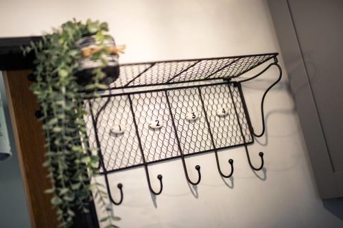 a wrought iron rack with a plant on a wall at Number 19 in Ripon