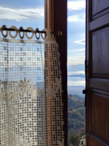 a view of a building from a window at Δωμάτια με Θέα in Volos