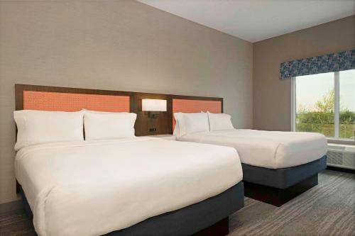 a hotel room with two beds and a window at Hampton Inn by Hilton Port Hope Cobourg in Port Hope