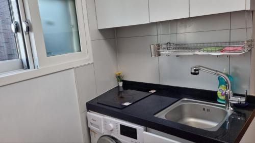 a small kitchen with a sink and a sink at Namsan Ville in Seoul