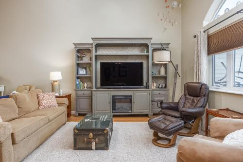 a living room with a large entertainment center with a television at Wondrous Willow Dog-Friendly Home in Fairbanks! in Lemeta