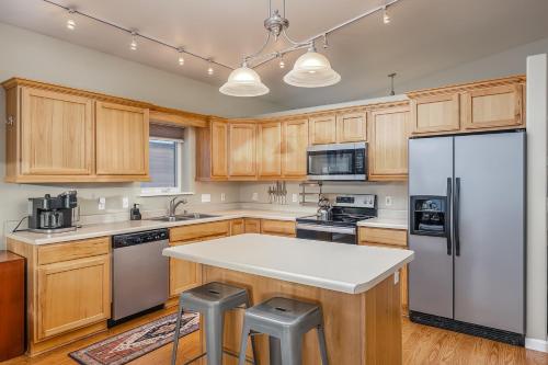 a kitchen with wooden cabinets and a white refrigerator at Wondrous Willow Dog-Friendly Home in Fairbanks! in Lemeta