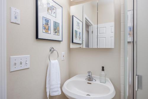 a white bathroom with a sink and a mirror at Wondrous Willow in Fairbanks