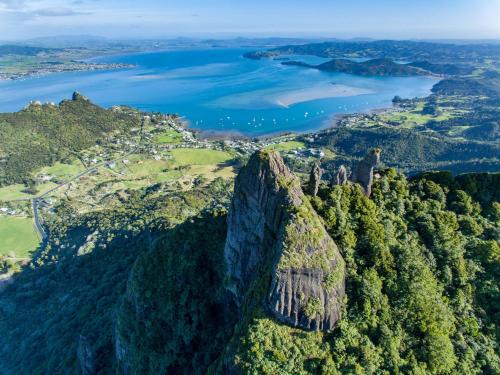 an aerial view of a mountain with a lake at Views Forever in Whangarei Heads