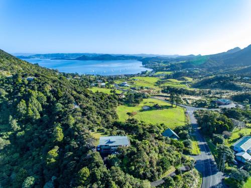 an aerial view of a town with a river and trees at Views Forever in Whangarei Heads