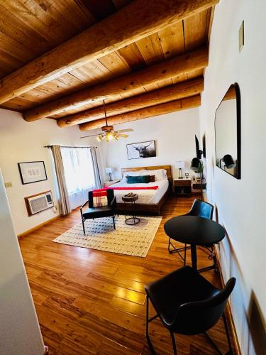 a living room with a couch and a table at Adobe Rose Boutique Inn in Artesia