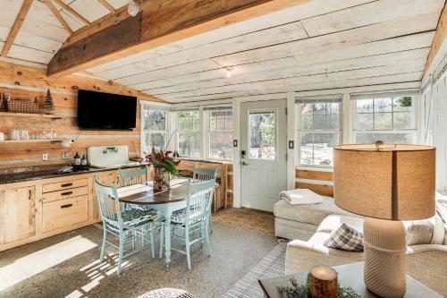 a kitchen and living room with a table and chairs at 4 Mi to Main Street Riverfront Minnesota Cabin in Elk River