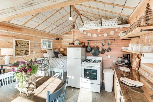 a kitchen and dining area of a tiny house at 4 Mi to Main Street Riverfront Minnesota Cabin in Elk River