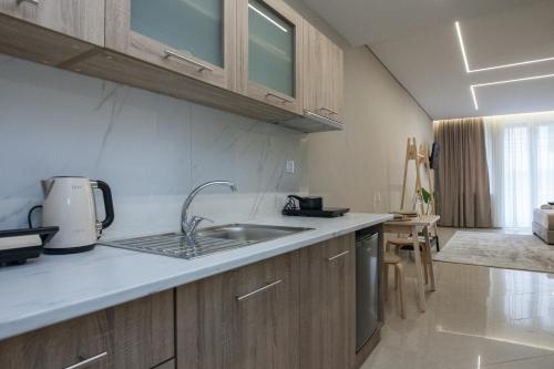 a kitchen with a sink and a counter top at Athens Luxury center Aparts F&G in Athens