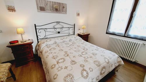 a bedroom with a bed and two windows at Le Terrazze Rooms & Studios in Ferrara