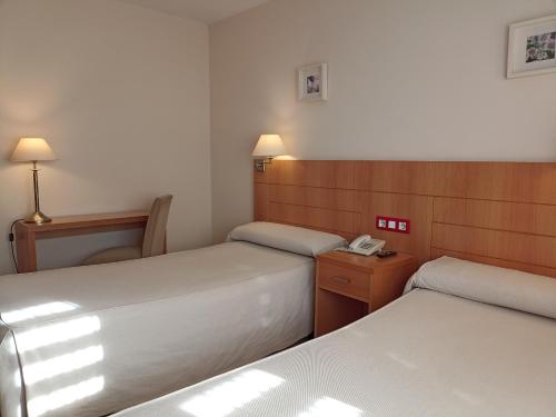 Postel nebo postele na pokoji v ubytování Hotel Villa de Zaragoza