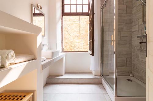 a bathroom with a shower and a sink at Remparts House in Mailhac