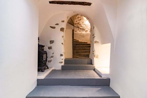 a staircase in a house with white walls and blue stairs at Remparts House in Mailhac