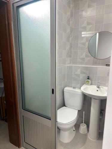 a bathroom with a toilet and a sink at T2 Centro cidade in Mindelo