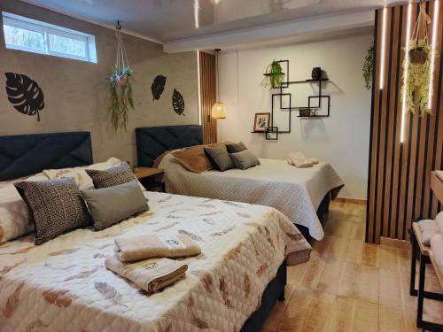 a bedroom with two beds with towels on them at Hope Aparta Lofts in Salento