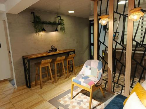 a living room with a dining room table and chairs at Hope Aparta Lofts in Salento