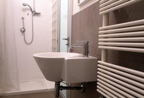 a white sink in a bathroom with a shower at Residence "I Centralissimi Mamiblu' " in Vasto