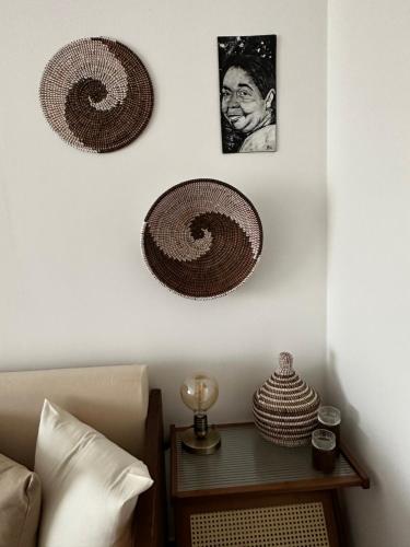 a bedroom with two baskets hanging on the wall at T2 Centro cidade in Mindelo