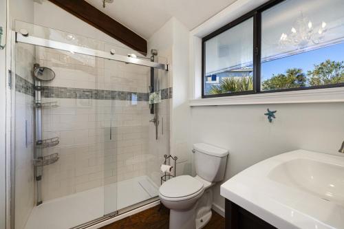 a bathroom with a toilet and a shower and a sink at Cedar Tides in Cedar Key