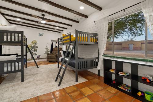 a bedroom with two bunk beds and a window at Rancho del Plata in Tucson