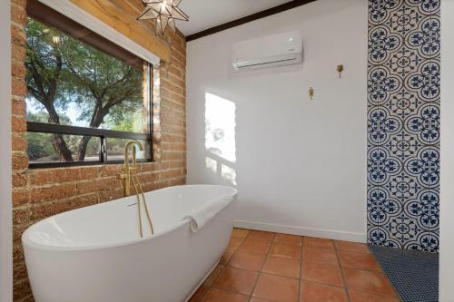 a bath tub in a bathroom with a window at Rancho del Plata in Tucson