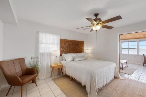 a bedroom with a bed and a ceiling fan at Gulf front with sand and water access in Cedar Key