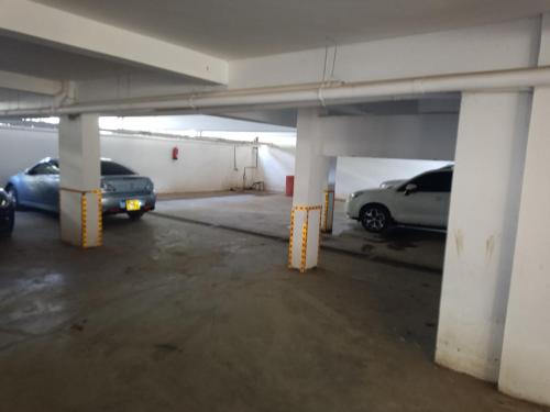 two cars parked in an empty parking garage at The Pearl of Juja in Juja