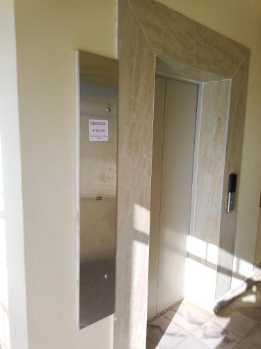 a hallway with a sign on the wall of a building at The Pearl of Juja in Juja