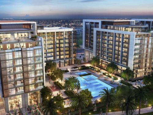 an aerial view of a large apartment complex with a pool at Tranquil 1 Bedroom Dubai Hills Escape in Dubai