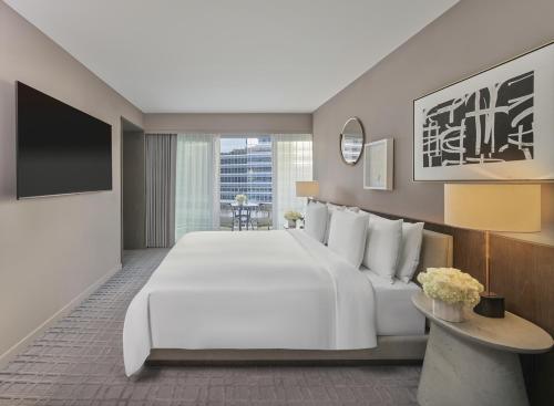 a hotel room with a large bed and a tv at Fairmont Century Plaza Los Angeles at Beverly Hills in Los Angeles