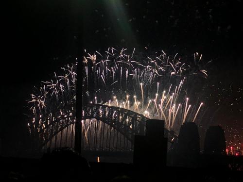 a bridge with fireworks exploding in the sky at Millers Point Home Harbourside in Sydney