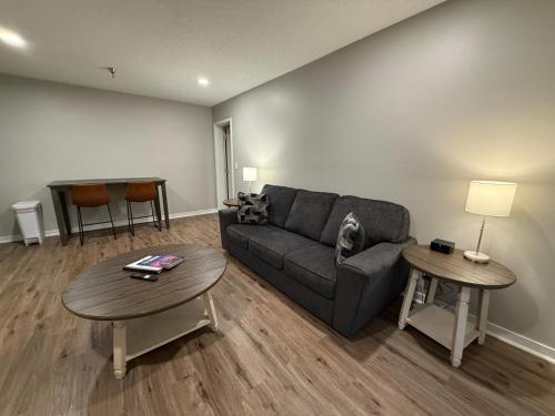 a living room with a couch and two tables at Central to Zoo and Baxter Arena, Pet Friendly in Omaha