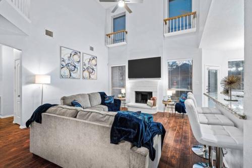 a living room with a couch and a tv at Game Room, Crib, Fenced Backyard, Relocation Stay in Frisco