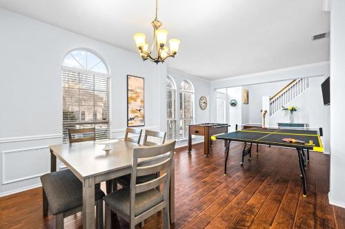 a dining room with a ping pong table in it at Game Room, Crib, Fenced Backyard, Relocation Stay in Frisco