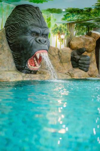 a statue of a gorilla with its mouth open in the water at HELLO VILLA & SPA in Hue