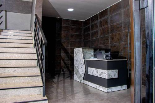 a lobby with a staircase and a cash register at Venue 360 in Freetown