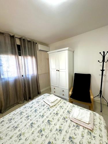 a bedroom with a bed and a cabinet and a chair at VUT de uso turístico Las Palomas in Arenas de San Pedro