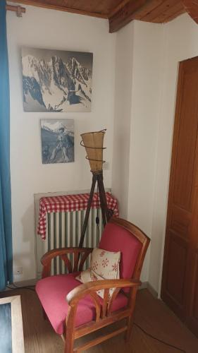 un salon avec un fauteuil à bascule et un radiateur dans l'établissement charmant t2 montagne, à Saint-Hilaire