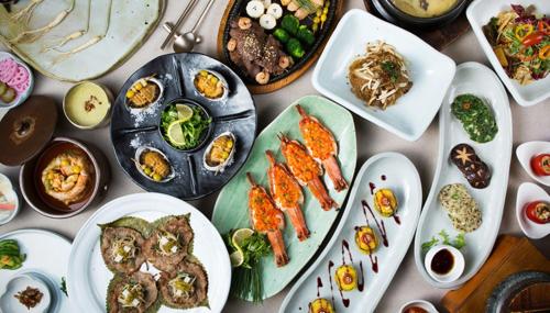 a table with plates of food and bowls of food at Grand InterContinental Seoul Parnas by IHG in Seoul