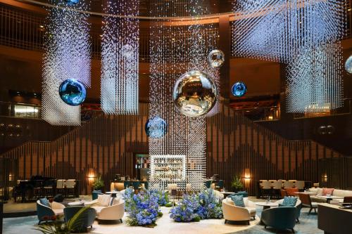 a lobby with tables and chairs and lights at Grand InterContinental Seoul Parnas by IHG in Seoul