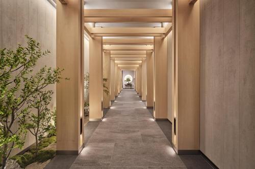 a corridor of corridors with columns and plants at Grand InterContinental Seoul Parnas by IHG in Seoul