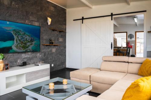 a living room with a couch and a table at Casa Terra Mar in Angra do Heroísmo