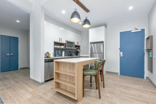 a kitchen with a table and chairs in a room at Staybridge Suites San Antonio Lackland AFB Area by IHG in San Antonio