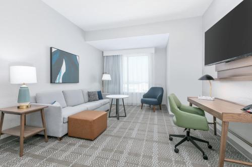a living room with a couch and a table at Staybridge Suites San Antonio Lackland AFB Area by IHG in San Antonio