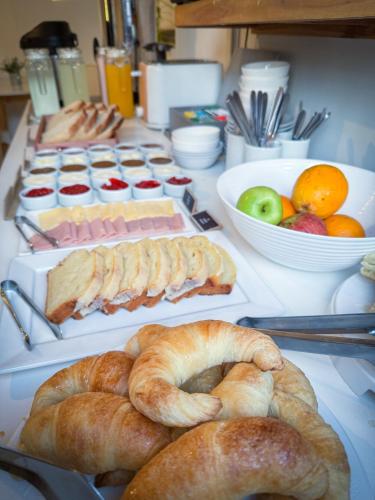 a table with breads and other foods on it at Hotel Alta Mendoza in Mendoza