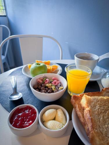 a table with a tray of breakfast foods and drinks at Hotel Alta Mendoza in Mendoza