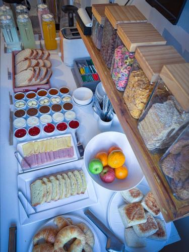 a table full of different types of bread and pastries at Hotel Alta Mendoza in Mendoza